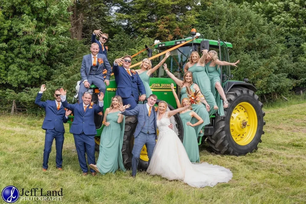 fun bridal party group photo on a john deere tractor at holy trinity church arrow 1