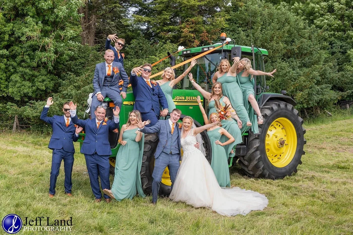 fun bridal party group photo on a john deere tractor at holy trinity church arrow 1